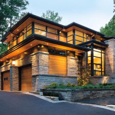 Modern home exterior featuring expansive black-framed windows, floor-to-ceiling glass, and abundant natural light.